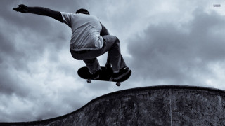 Man skateboarding cement wall cloudy - a skateboard free wallpaper