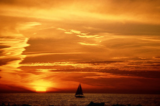Sailboat ocean sunset dawn sky - a sailboat free wallpaper