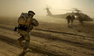 Soldiers walking dirt field helicopter 2 - a foggy day free wallpaper