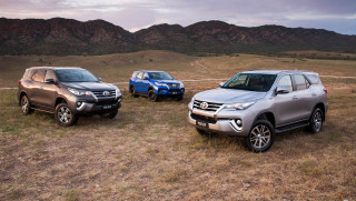 Suvs parked field mountains cloudy - anson maddock free wallpaper