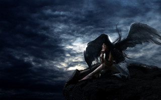 Woman wings sitting rock dark - a cloudy sky behind her free wallpaper