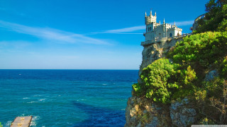 Castle cliff ocean boat blue - the water below free wallpaper