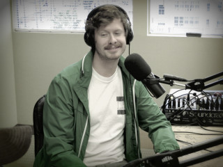 Man headphones microphone green jacket - professional photo free wallpaper