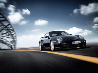 Black porsche driving road tall - a black porsche free wallpaper