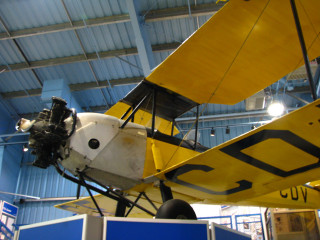 Yellow plane building blue ceiling - front view free wallpaper