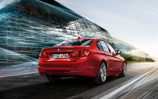 Red car driving street tall 2 - a tall building free wallpaper