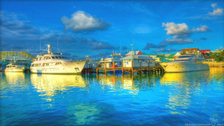 Boats docked pier water cloudy - a cloudy sky above them free wallpaper