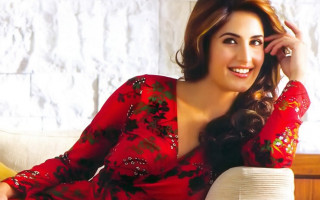 Woman red dress couch smiling - seductive smile free wallpaper