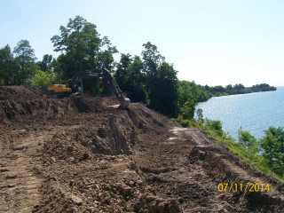 Dirt pile next to water - a body of water free wallpaper