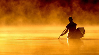 Man paddling canoe lake sunset - a canoe free wallpaper