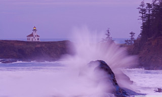 Lighthouse rocky cliff wave crashing - mist free wallpaper