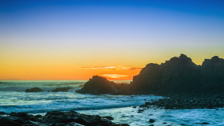 Sunset ocean rocks water foreground - a large rock formation in the foreground free wallpaper