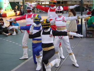 Costumed people sidwalk arms raised - a sidewalk free wallpaper