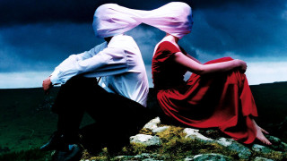 Man woman rock cloudy sky - a dark cloud free wallpaper