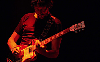 Man playing guitar dark room 2 - zabrocki free wallpaper