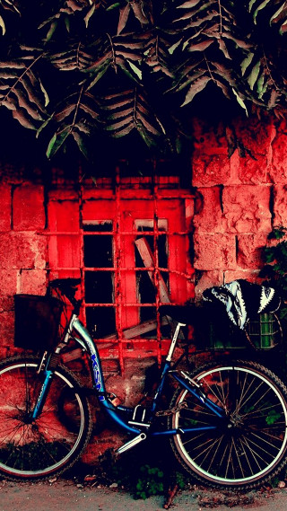 Bike parked red brick building - the side of it free wallpaper for mobile