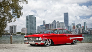 Red classic car city skyline - a red classic car free wallpaper