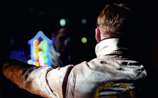 Man white jacket playing video - a dark room free wallpaper