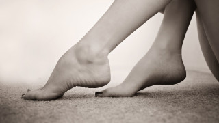 Bare feet sitting floor crossed - their leg free wallpaper