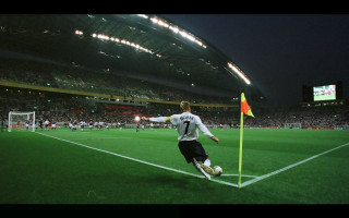 Soccer player kicking night stadium - a soccer ball free wallpaper for desktop