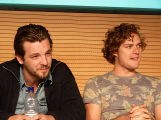 Two men sitting screen water - a screen free wallpaper