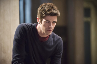 Man sitting serious looking camera - free dark wallpaper for desktop