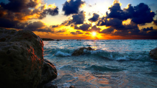 Sunset ocean rock formation water 4 - a rock formation in the foreground free wallpaper