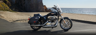 Motorcycle parked ocean cliff beach - a parking lot next free wallpaper for desktop