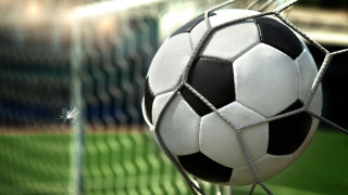 Soccer ball stuck in net - a soccer ball free wallpaper