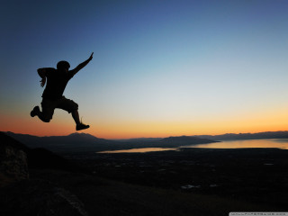 Man jumping skateboard sunset lake - a skateboard in front free wallpaper