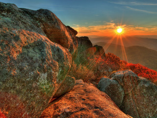 Sunset rocky mountain bright sun - a bright sun in the distance free wallpaper