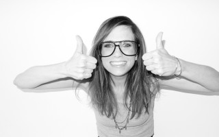 Woman glasses thumbs up smiling - both hand free wallpaper