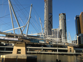 Bridge train building blue sky - a tall building in the background free wallpaper