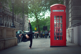 Man handstand phone booth city - david annand free wallpaper