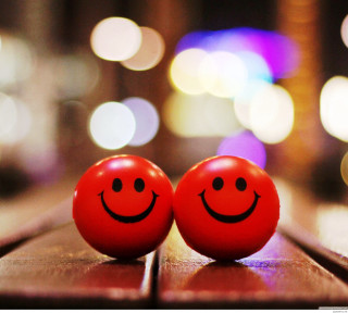 Two red balls with faces - a table in front free wallpaper for tablet