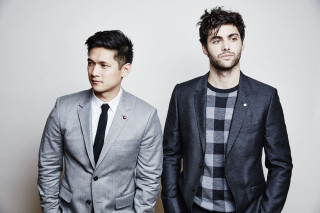 Two men suits white wall - a black tie free wallpaper