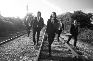 Men suits walking train tracks - art brut free wallpaper