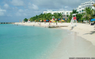 Beach white building blue water - a white building free wallpaper