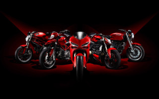 Motorcycles lined up black background 2 - a red light behind them free wallpaper