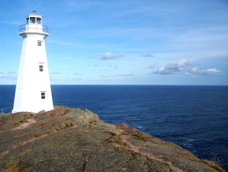 Lighthouse rocky outcropping ocean blue - a lighthouse free wallpaper