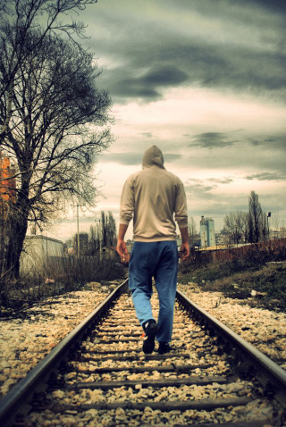 Man walking train track tree - liminal free wallpaper for mobile