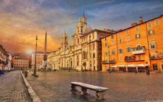 Bench cobblestone street tall building - a tall building free wallpaper