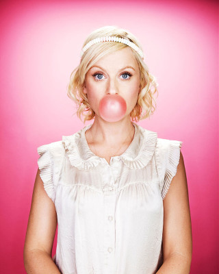 Woman blowing bubble pink background - free happy birthday wallpaper for mobile