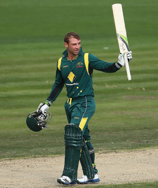 Man batting green uniform outdoors - free sports wallpaper for mobile