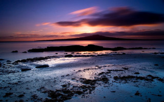 Sunset rocky beach small island - a small island in the distance free wallpaper