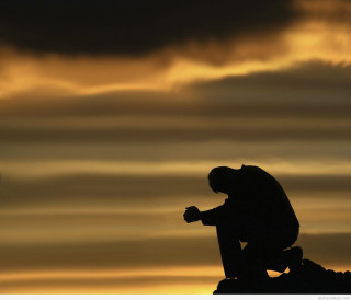 Silhouette man sitting rock cross - a rock free wallpaper