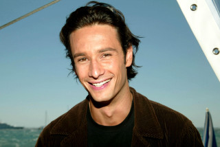 Smiling man boat ocean background - a boat in the background free wallpaper