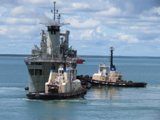 Tug boats large ship ocean - a tilt shift photo free wallpaper