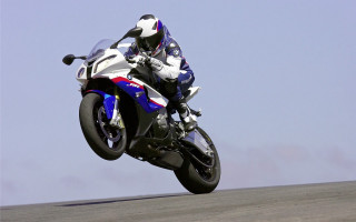 Motorcycle trick air hillside sky - cybernetic free wallpaper