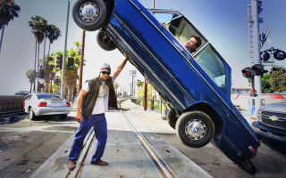 Man standing car upside down - down free wallpaper